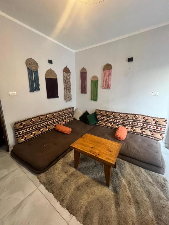 a living room with a large couch and a table at Tree house in Dahab