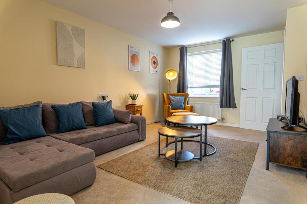 a living room with a couch and a table at Sherbet House in Water Orton