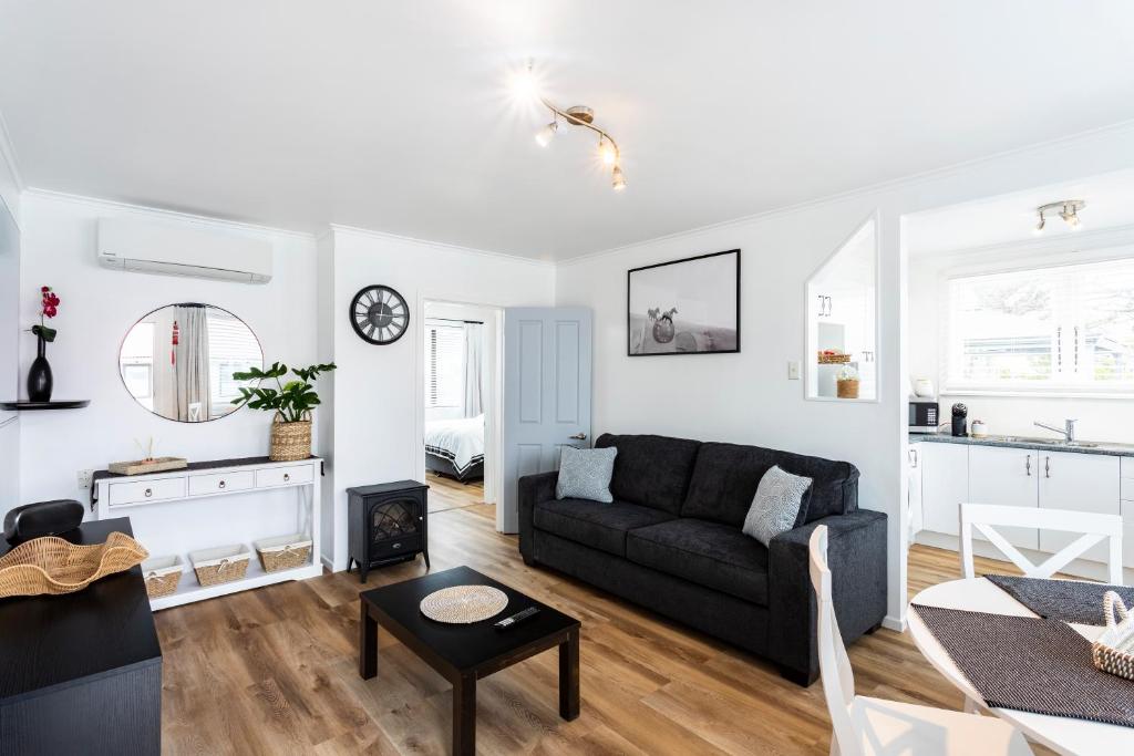 a living room with a couch and a table at Matahari Apartments and Villas in Upper Hutt