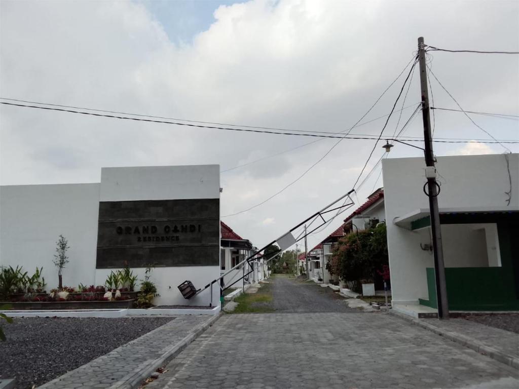 an empty street with a sign on the side of a building at Homestay Tata in Bugisan