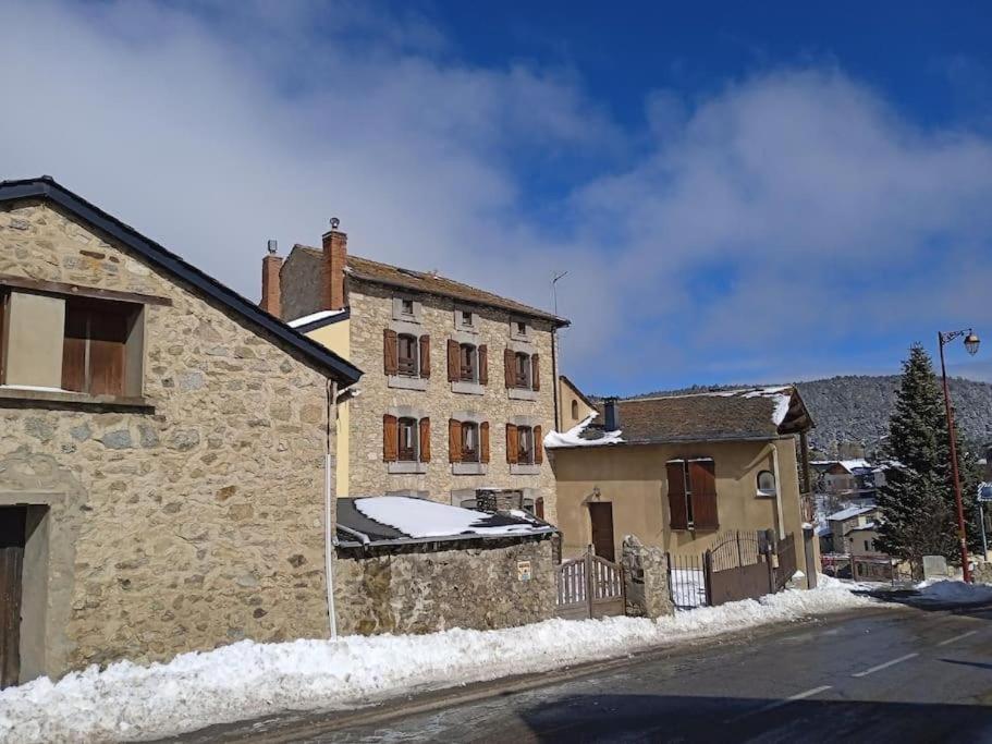 an old stone building with snow on the roof at 90 m2, 3 chambres, coeur de village, 10 mns des pistes, navette gratuite in Bolquere Pyrenees 2000