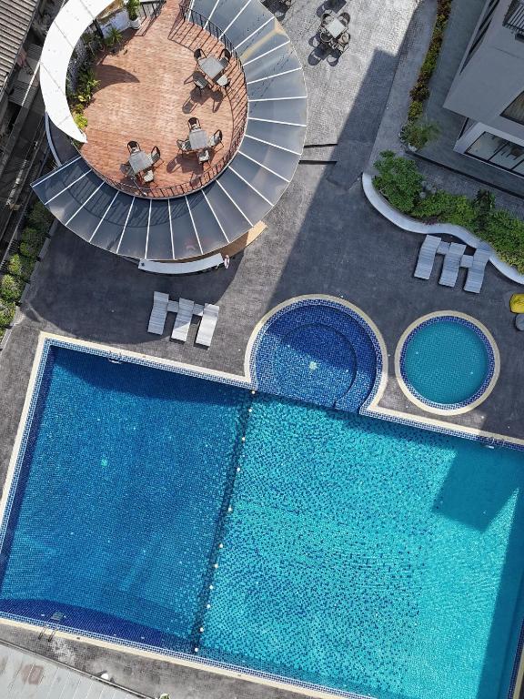 An aerial view of a large pool complex with two round plunge pools.