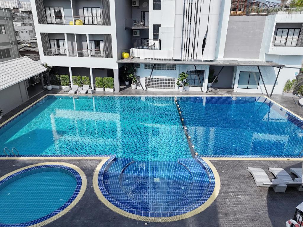 An elevated view over a large pool complex in the hotel courtyard.