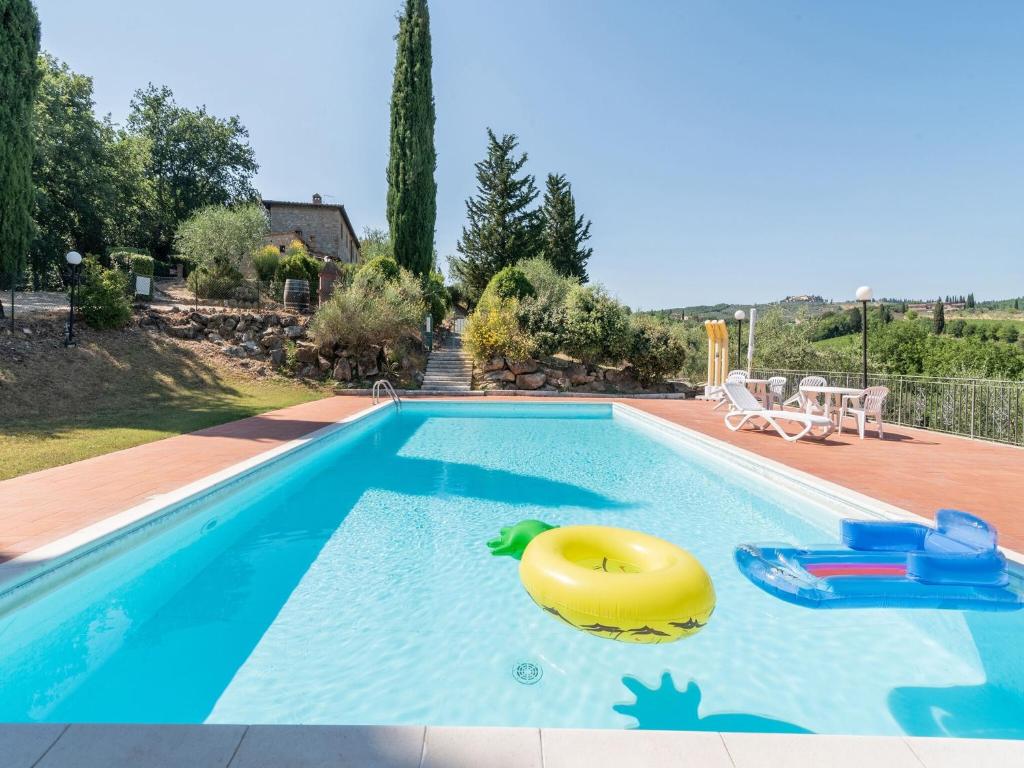 a swimming pool with a yellow float in the water at Sun-kissed holiday home in Monti di Sotto