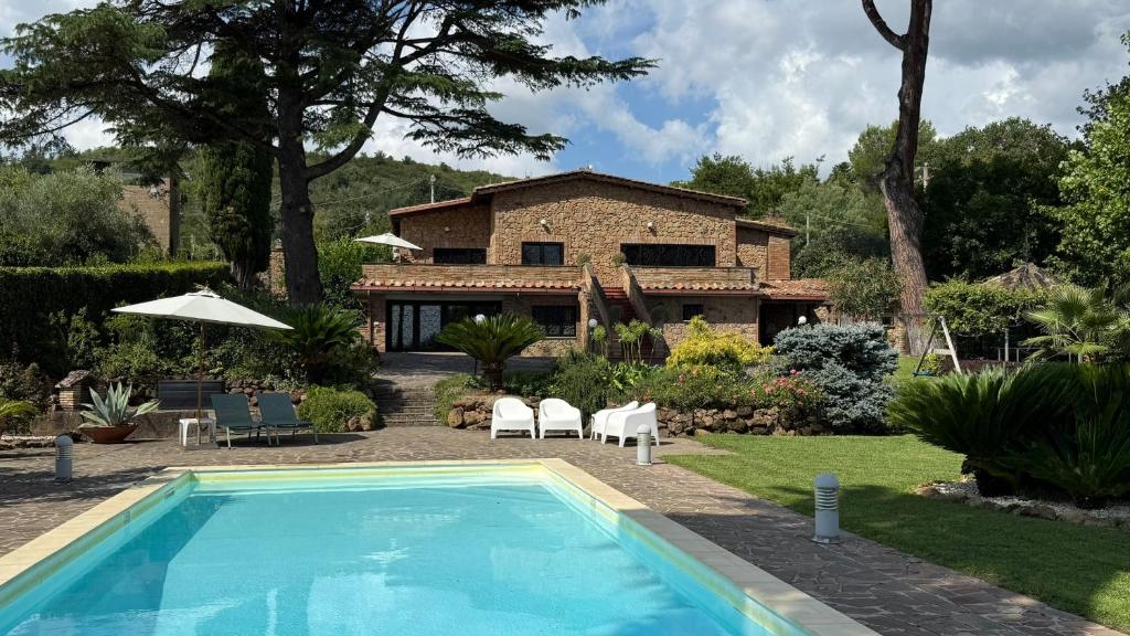 a house with a swimming pool in front of a house at Villa Valentina in Bracciano