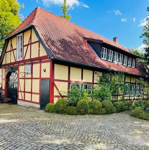 a red and white building with a red roof at Altes Forstamt in Wennigsen