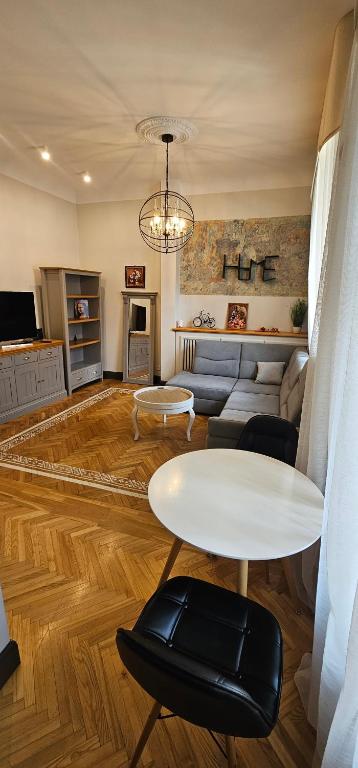 a living room with a table and a couch at Al Pacino Family Lux Apartment in Rīga