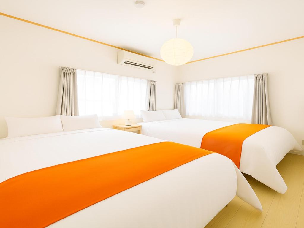 two beds in a room with white and orange at Ikebukuro-Otsuka-10min ShinOtsuka Sta-For families and groups-Switch-net-Mobile Wi-Fi in Tokyo