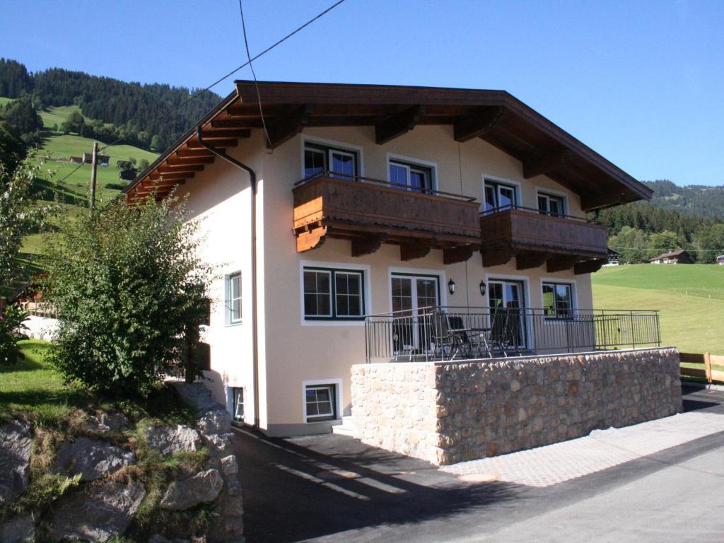 a house with a balcony on top of it at Holiday Home Brixen near Skiwelt Slopes in Brixen im Thale