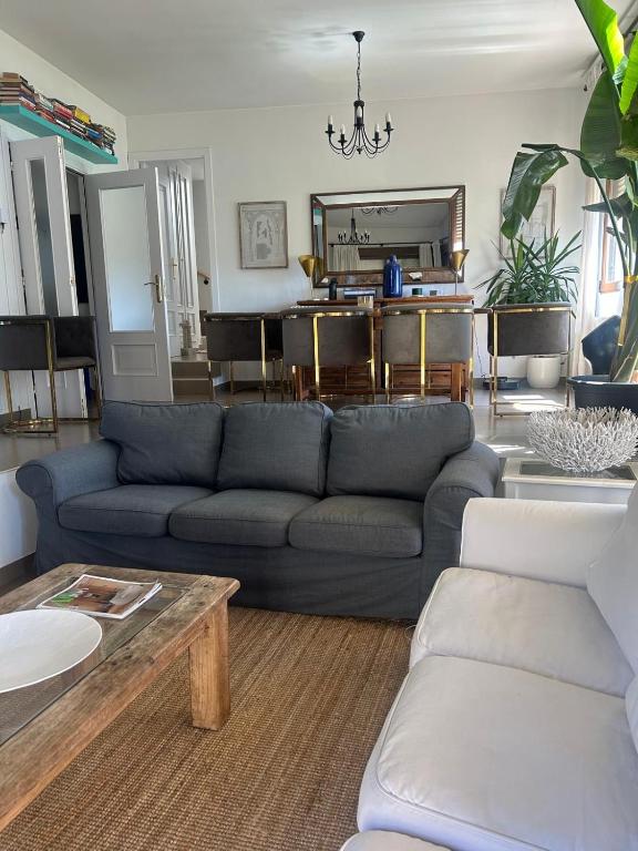 a living room with a blue couch and a table at Casa Rural Teja Vieja in Duruelo