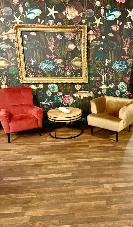 a living room with two chairs and a table at Apartment 2 in Stockach
