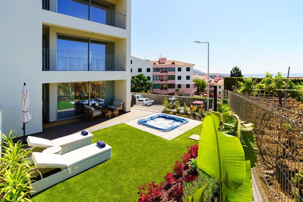 a view of a house with a yard with a garden at Star Lit Jacuzzi Apartment in Câmara de Lobos