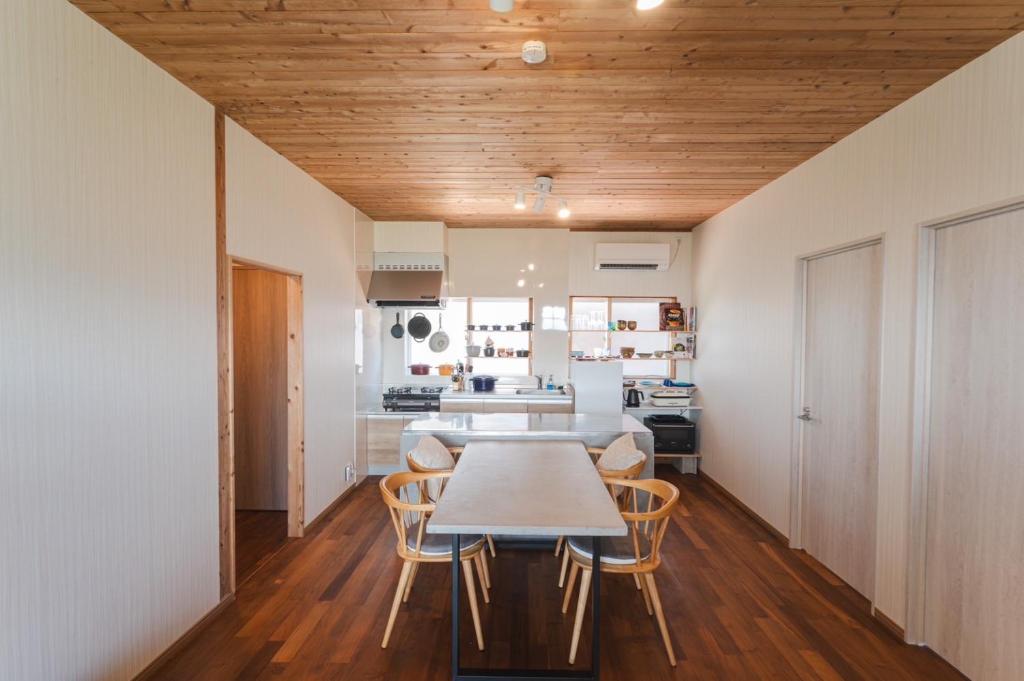 a kitchen with a table and chairs in a room at Haruhiya in Ishigaki Island