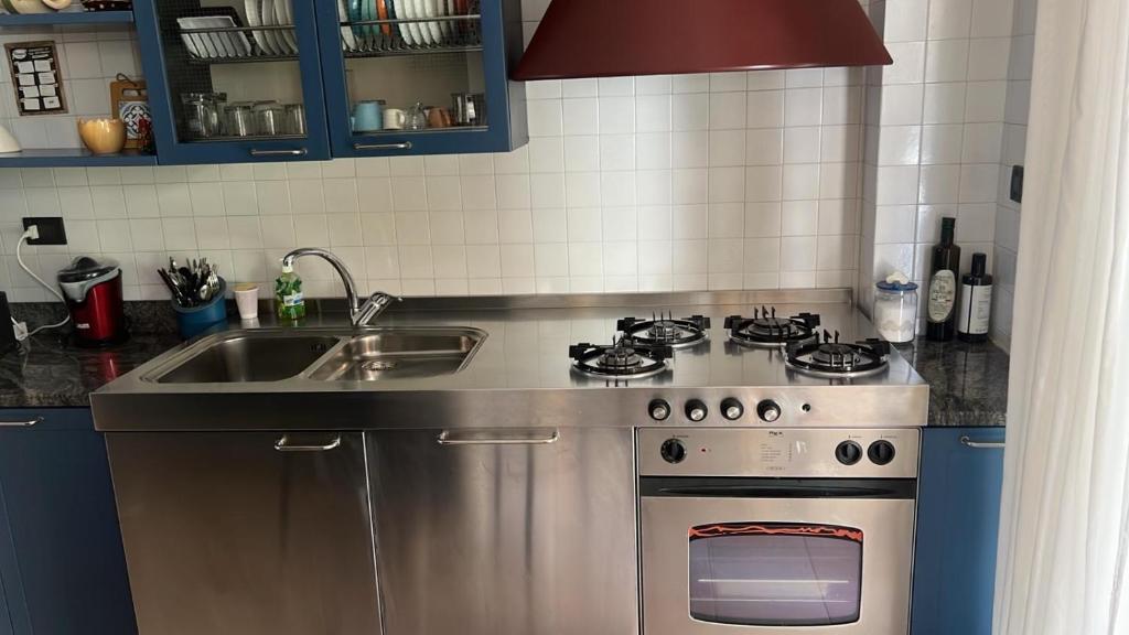 a kitchen with a stainless steel stove and a sink at il campanile in Gaeta