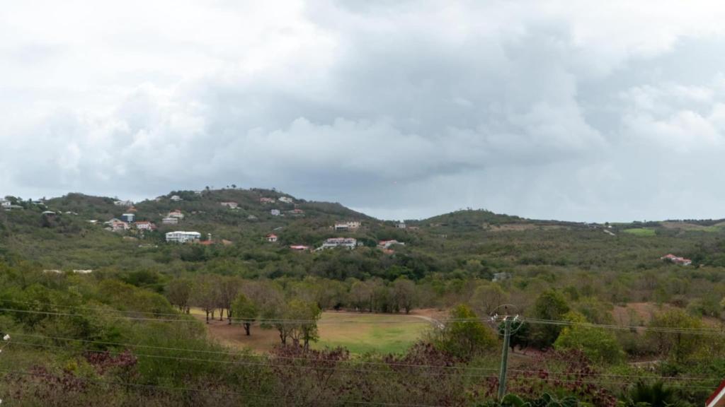 a view of a field with houses on a hill at Paradise cove villa in Gros Islet
