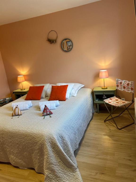 a bedroom with a bed with two tables and two lamps at Côté Poules 