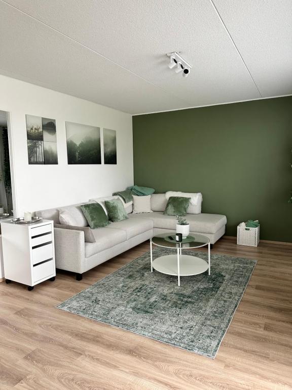 a living room with a couch and a table at Tranquil Apartment in Vantaa in Vantaa