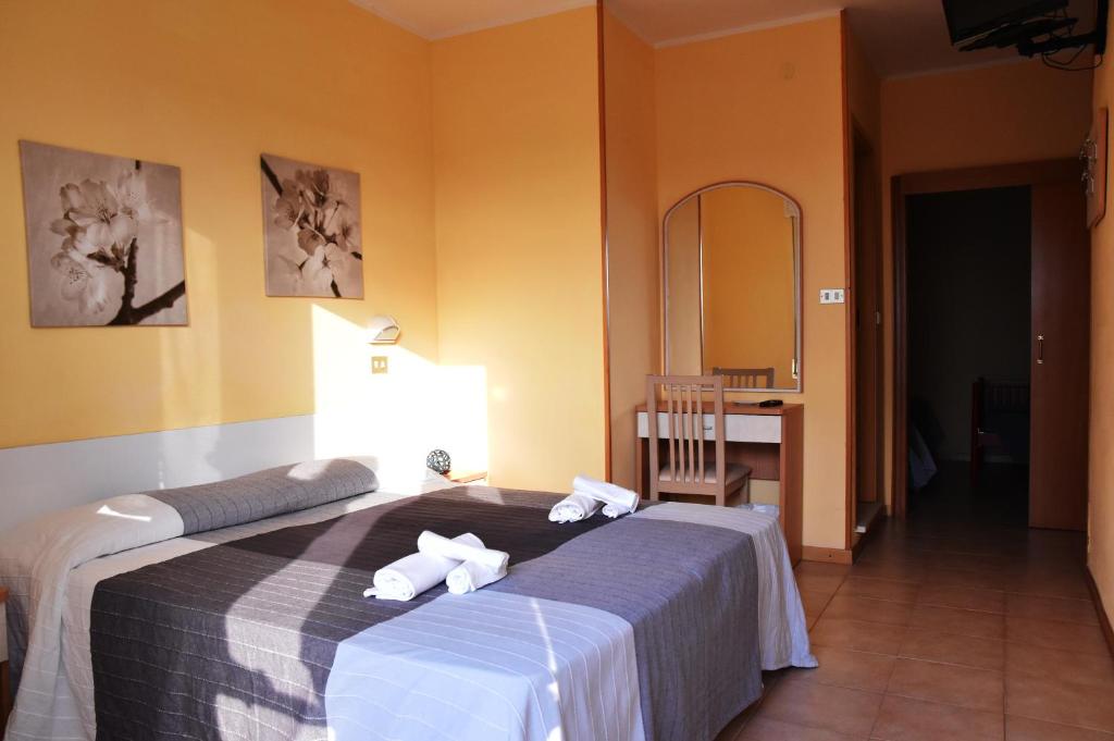 Postel nebo postele na pokoji v ubytování Hotel Graziella
