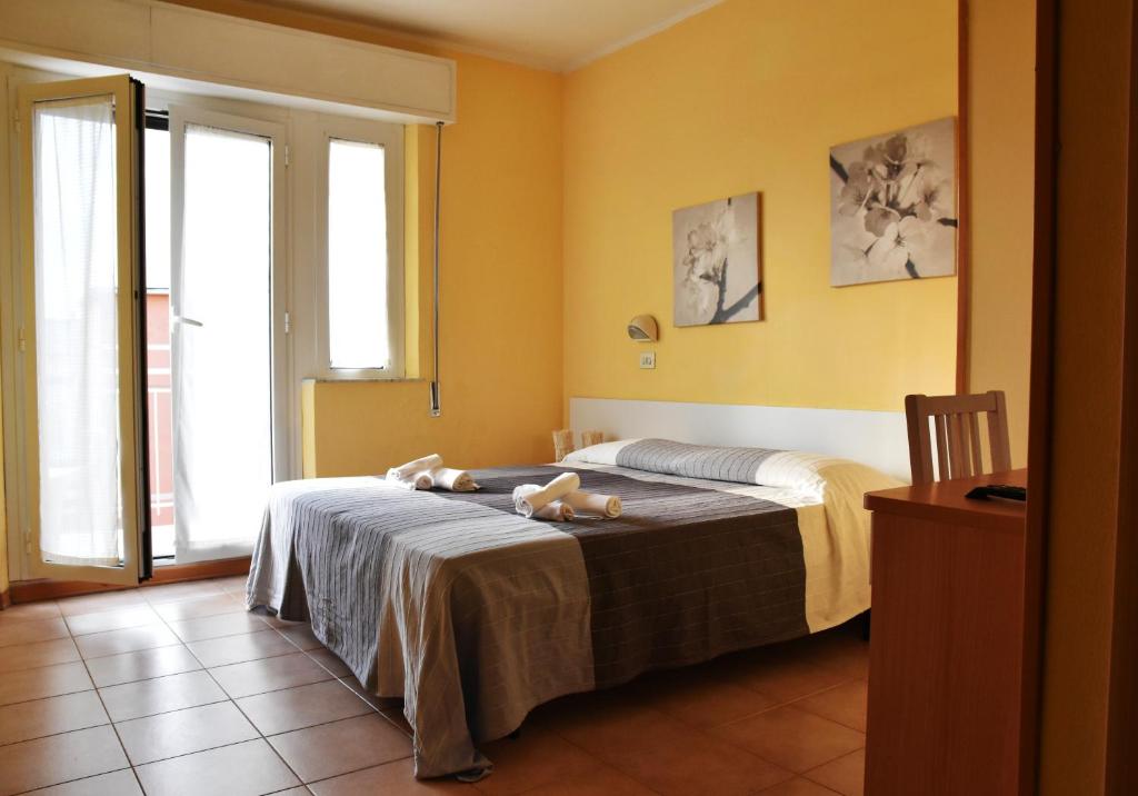 Postel nebo postele na pokoji v ubytování Hotel Graziella