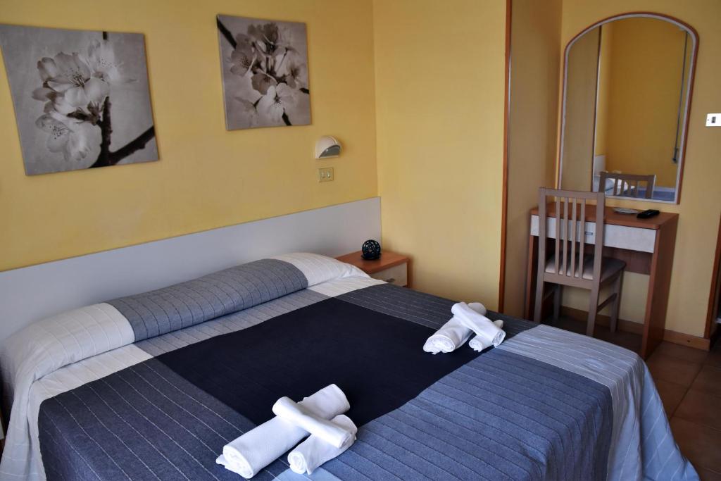 Postel nebo postele na pokoji v ubytování Hotel Graziella
