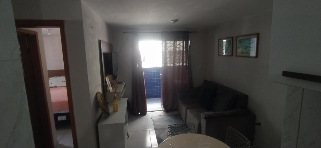 a living room with a couch and a window at Impérium residence clube in João Pessoa