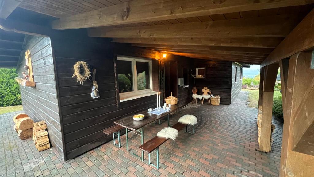 two people sitting on the patio of a house at Die Waldstube in Bromskirchen