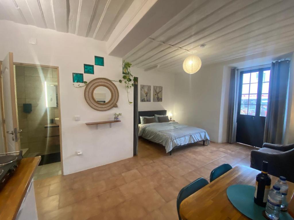 a bedroom with a bed and a table in a room at Casa lovits - Cozy One-Bedroom Apartment with Modern Comforts in Espinhal