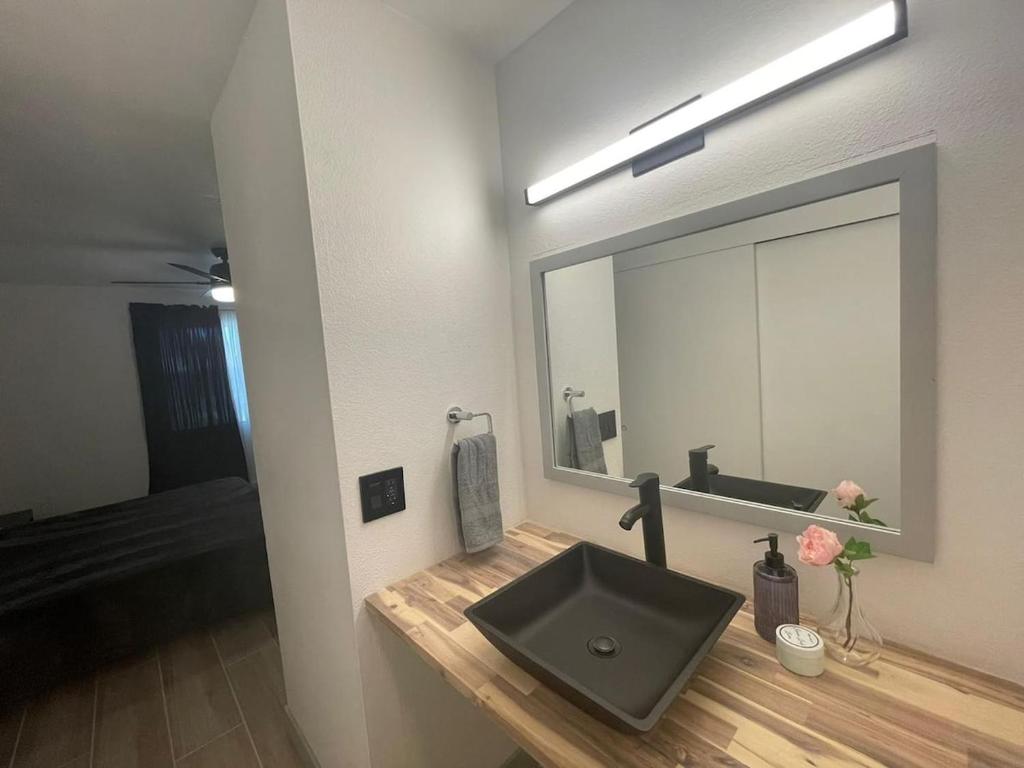 a bathroom with a sink and a large mirror at Msg for 5off 3Bed2Bath KingKingQueenBeds N PHX in Phoenix