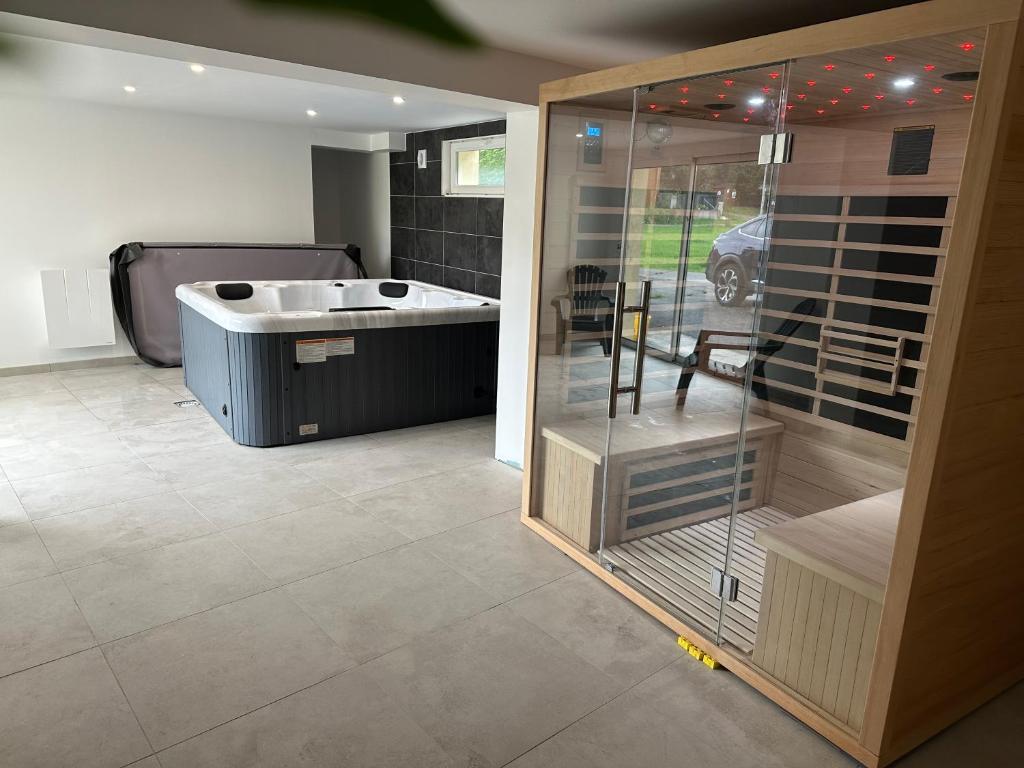 a bathroom with a tub and a sink in a room at Nouveauté Gite la virée verte in Vagney