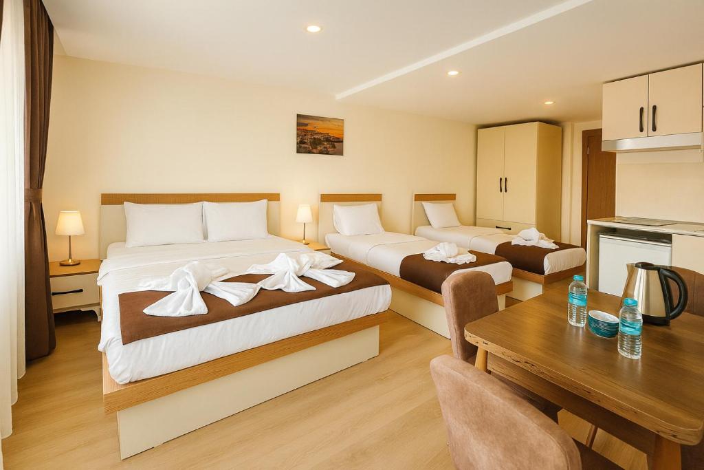 a hotel room with two beds and a table at VALENCE HOTEL Taksim in Istanbul