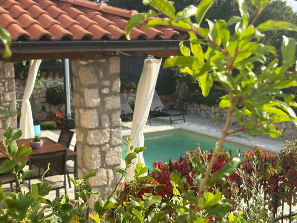 a backyard with a swimming pool and a house at Vintage Residence Dramalj, pool self-use in Dramalj
