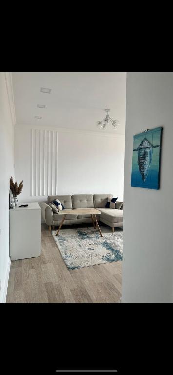 a living room with a couch and a table at ЖК Green Plaza Aktau Двухкомнатная большая in Aktau