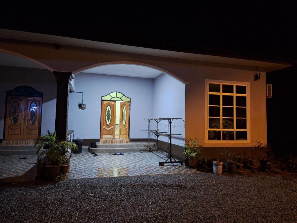 a room with a door in a house at night at DTM Homestay 1 in Tanah Merah