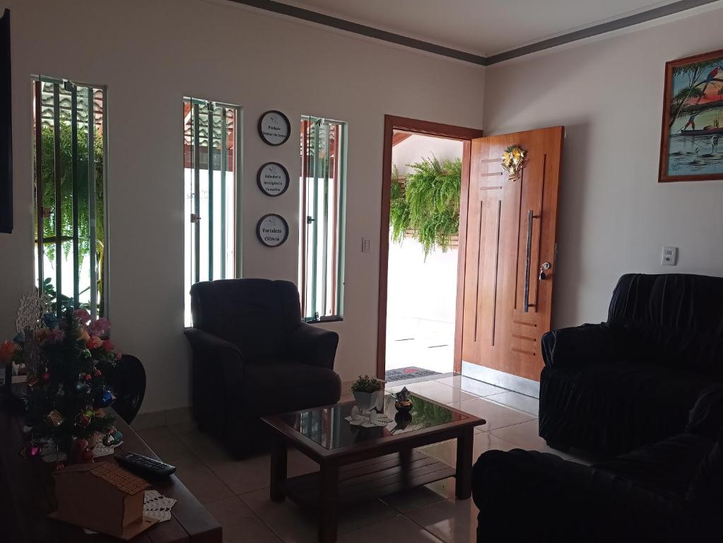 a living room with two chairs and a table at Aconchego, lazer IC in Pirenópolis