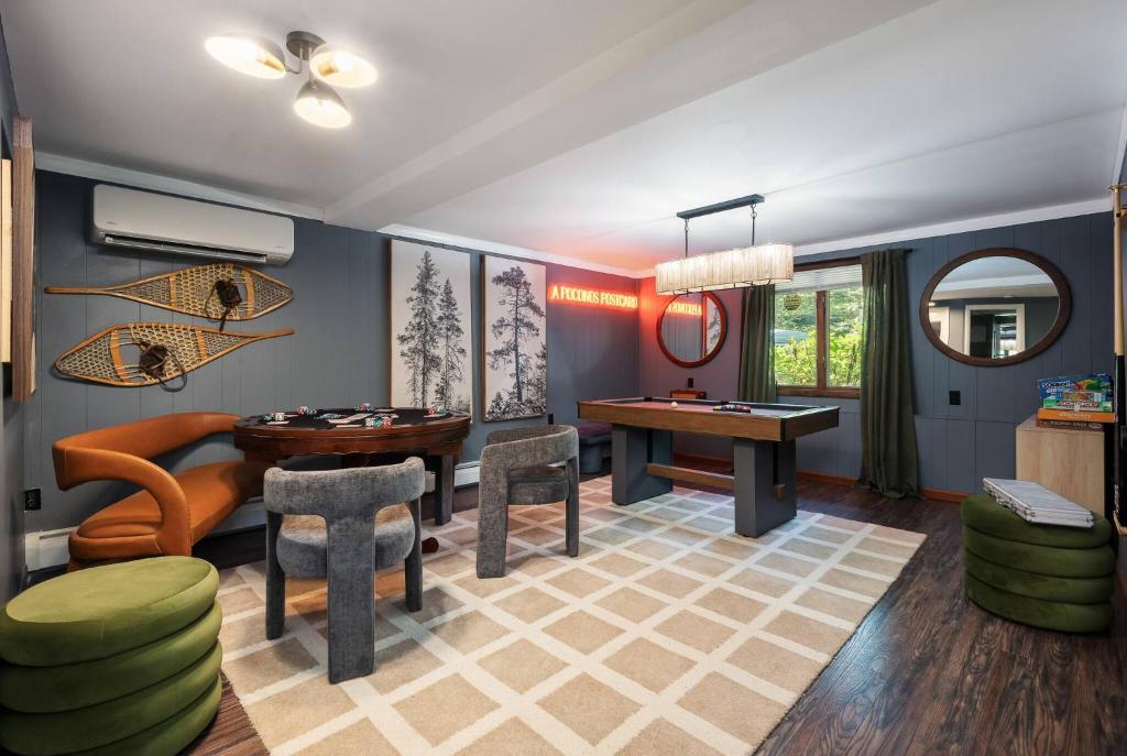 a living room with a table and chairs at Theater*2 Game Rooms *Sauna *Hot Tub*Fall Specials in Blakeslee