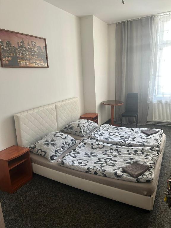 a bedroom with a bed and a table and a window at Loftel v centru Ostravy in Slezská Ostrava