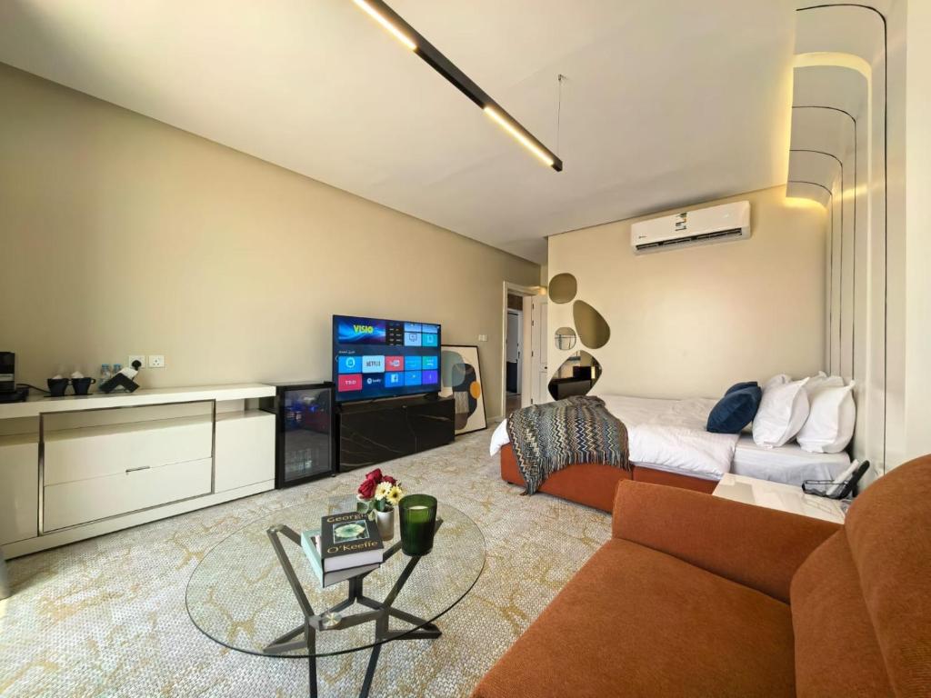 a living room with a couch and a tv at مهند هوم 24 in Al Khobar