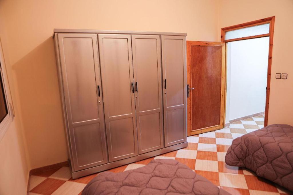 a bedroom with two closets and a bed at najmatrif in Driouch