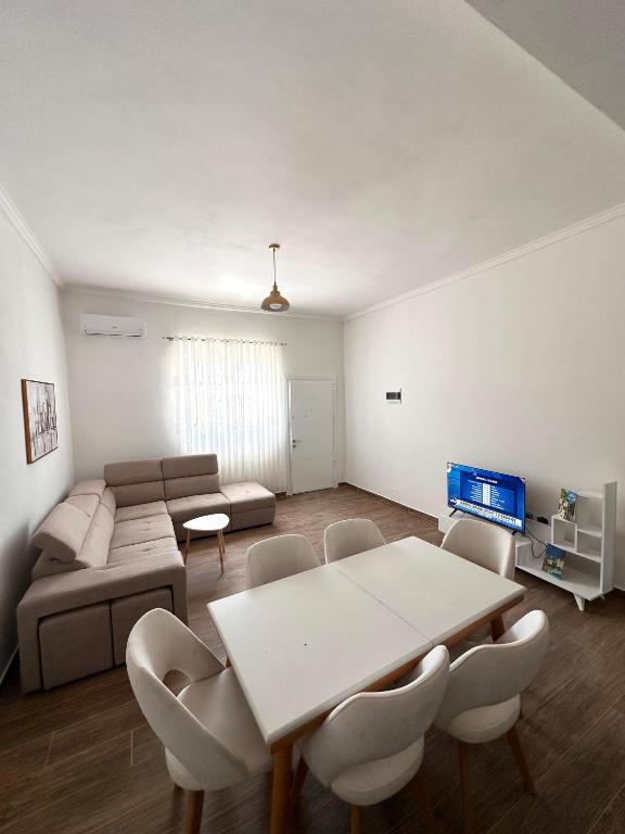 a living room with a table and a couch at Villa 2211 Berat in Uznovë