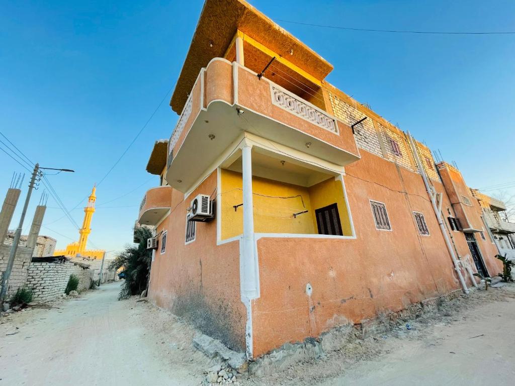 an orange building with a sign on the side of it at Aylan in Siwa