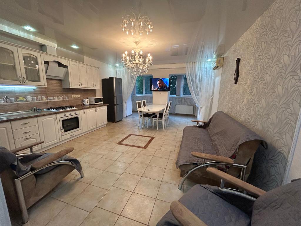 a kitchen and living room with couches and a table at Двохкімнатна квартира біля моря in Chornomorsk