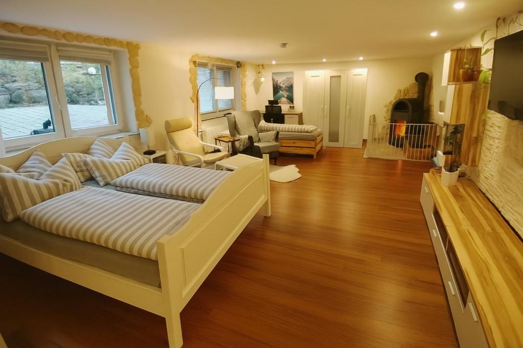 a living room with two beds and a couch at Ferienwohnung Hecht - Biketrail Fun & Relaxing in Wolfegg