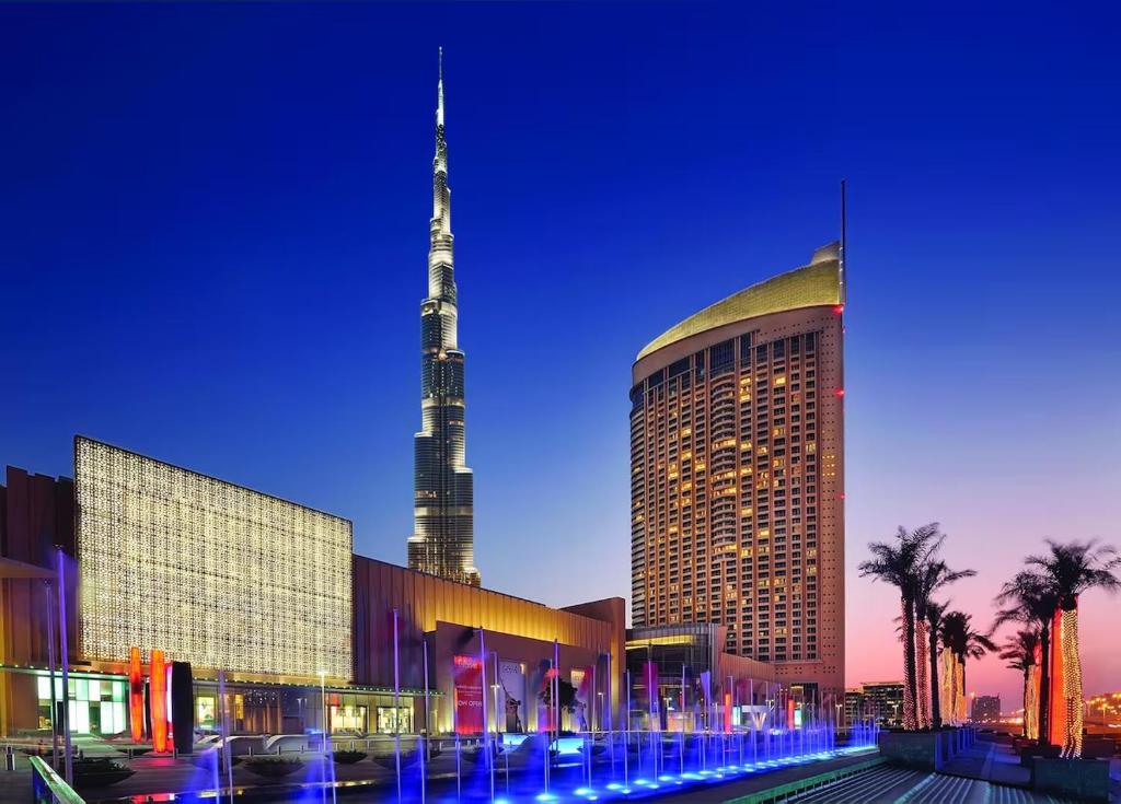 a large building with a tall tower in the background at Creston Suites The Dubai Mall Residences in Dubai