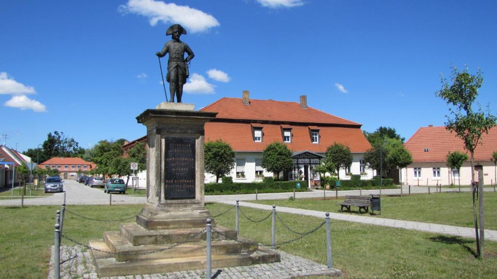 una estatua de una mujer parada en un parque en Hotel Alte Försterei, en Kloster Zinna
