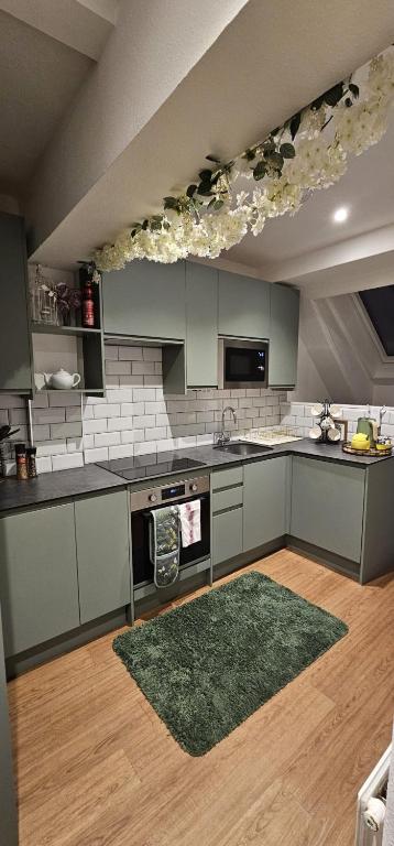 a kitchen with gray cabinets and a green rug at Amazing Central Windsor Flat Contractors welcome in Windsor