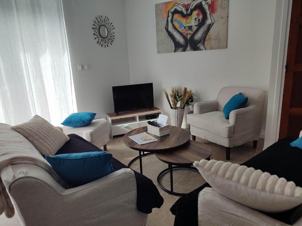 ein Wohnzimmer mit Sofa und Tisch in der Unterkunft L'Adonis - Family home near Equiblues WIFI in Saint-Agrève