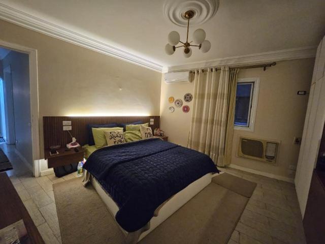 a bedroom with a large bed and a window at hotel apartments cairo downtown in Cairo