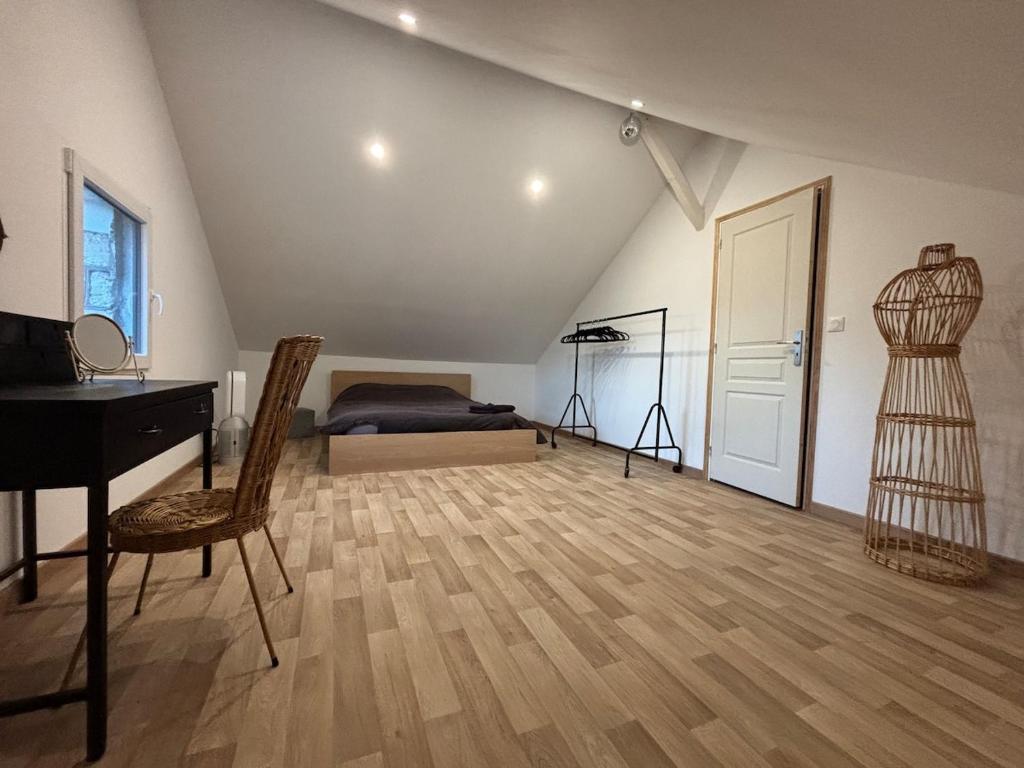 a bedroom with a bed and a desk and a piano at 1930 house in La Marbellière, 2 bedrooms in Joue-les-Tours