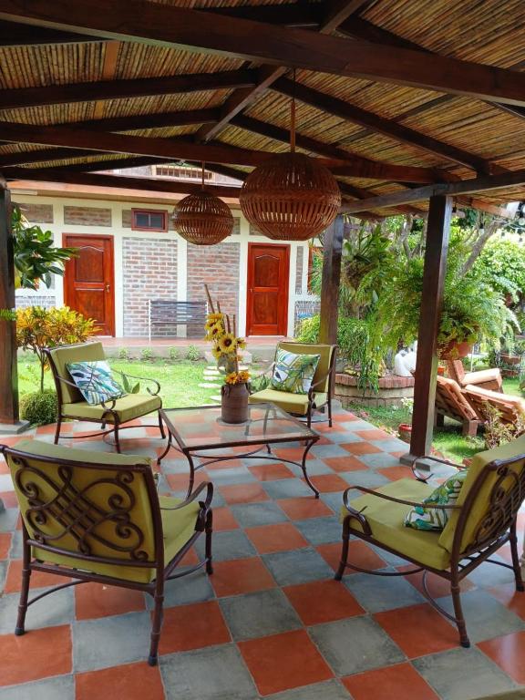 four chairs and a table on a patio at Hostal Don Miguel in Rivas
