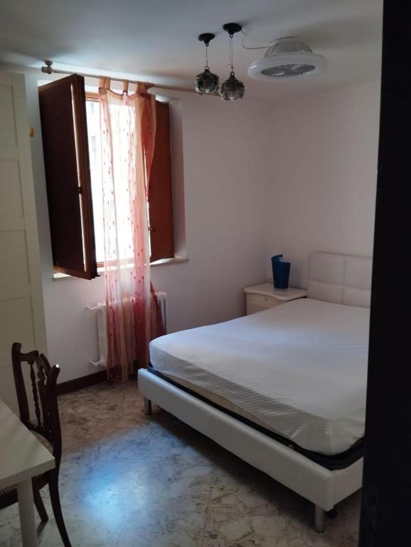 a bedroom with a white bed and a window at Al Castello 2 in Bari